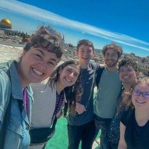 Group selfie with friends, historic dome in the background.